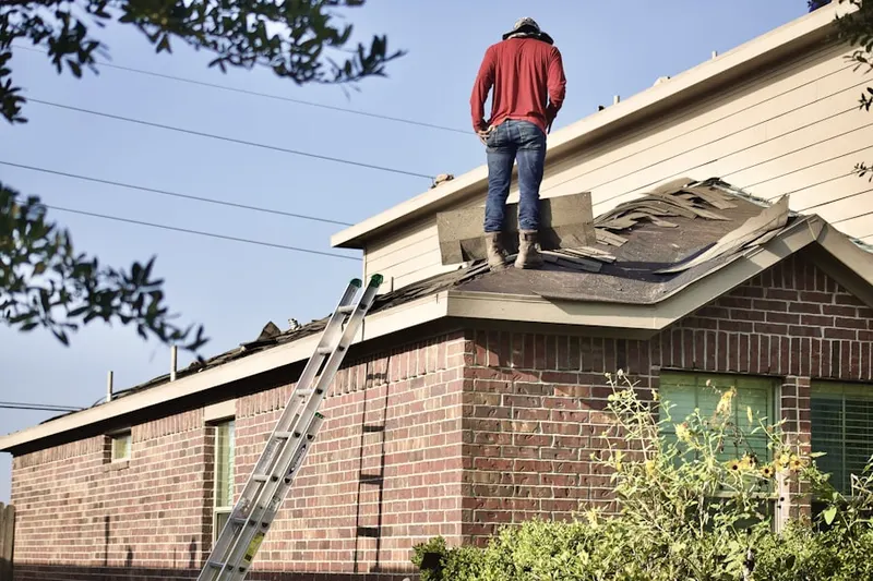 Professional roofer working on a residential roof in Potomac Grove